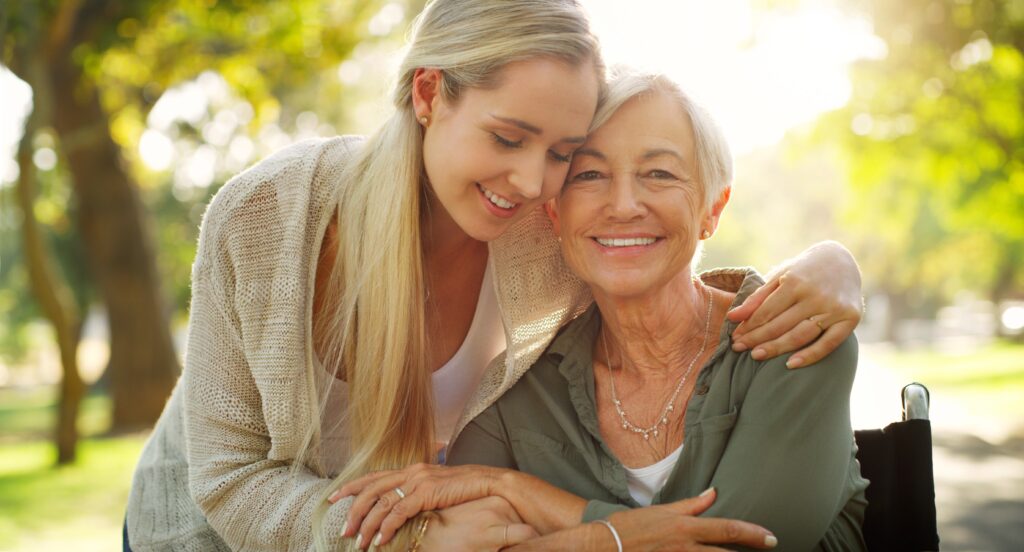 Banner image showing younger women caring for elderly woman